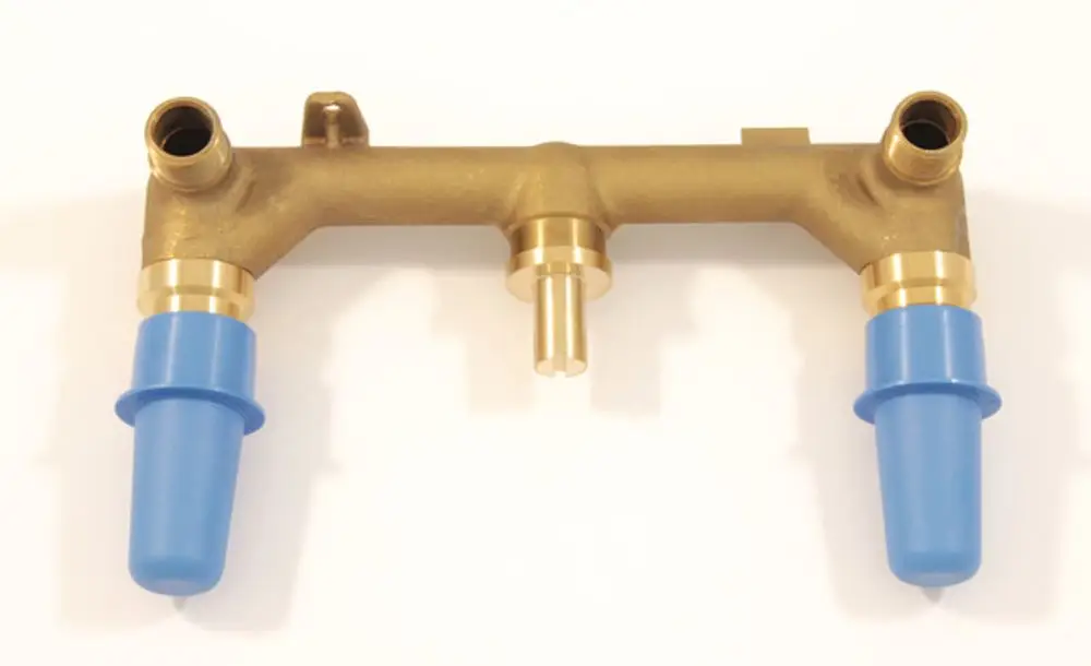 Brauner UP-Bausatz mit zwei blauen Schutzkappen, geeignet für eine Zweigriff-Wand-Waschtischarmatur von Ideal Standard. Oben drei Anschlussstellen.